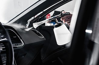 Picture of a means of transportation cleaning on a dashboard in a car