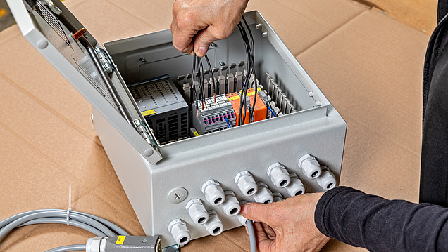 Picture of 2 hands carrying out electrical work on a switching element