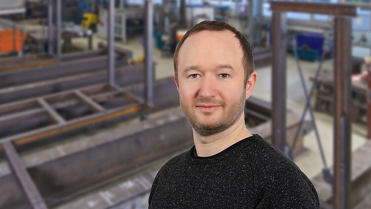 Picture of a man standing in front of a steel construction