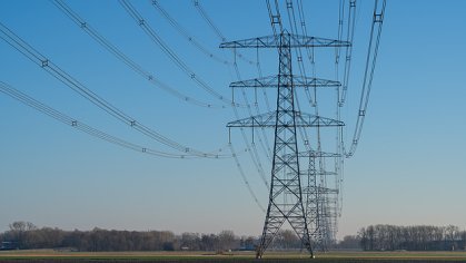 Image of a row of power lines against a blue sky