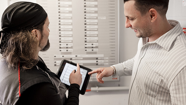 Photo of a property manager and a technician inspecting an installation