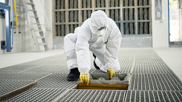 Picture of a person in a protective suit changing a part of an air system