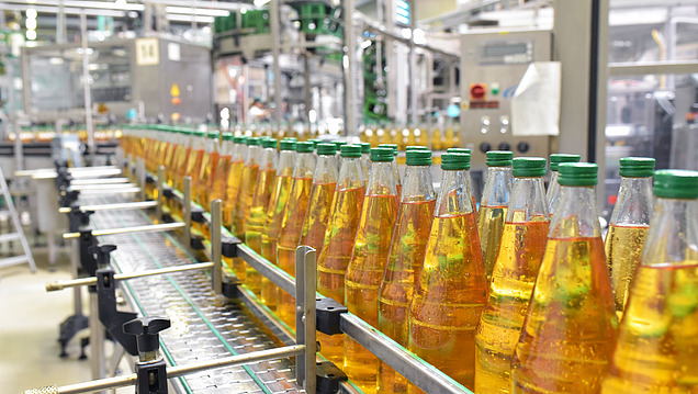 Picture of a treadmill with bottles of yellow liquid running along it