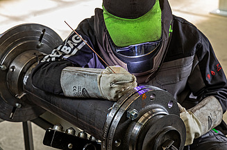 Image of a person performing industrial facility services in the form of welding work