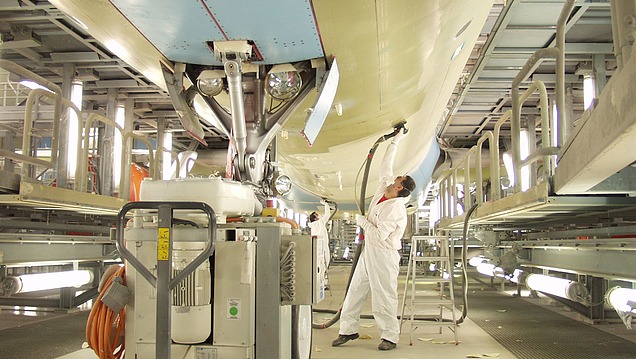 Picture of a person polishing the outside of an airplane