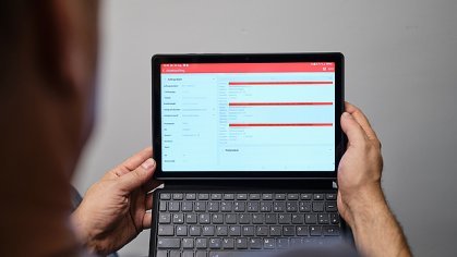 Image over the shoulder of a man looking at the analysis on a tablet