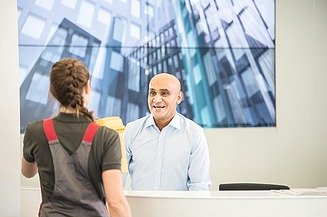 Picture of the reception and security service in an office with two employees