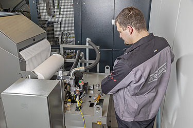 Picture of a man carrying out machine and system services on a paper machine