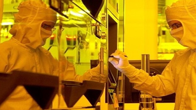 Picture of a person in a protective suit standing in a laboratory