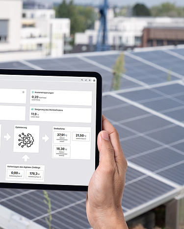 Photo of a tablet in front of photovoltaic systems