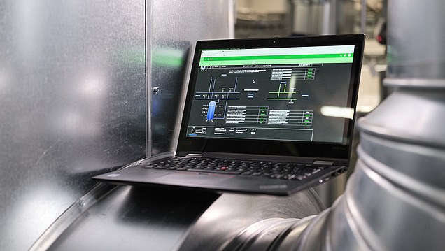 Image of a laptop on the pipe of a technical system