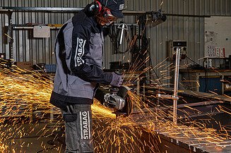 Picture of a person cutting steel with an angle grinder